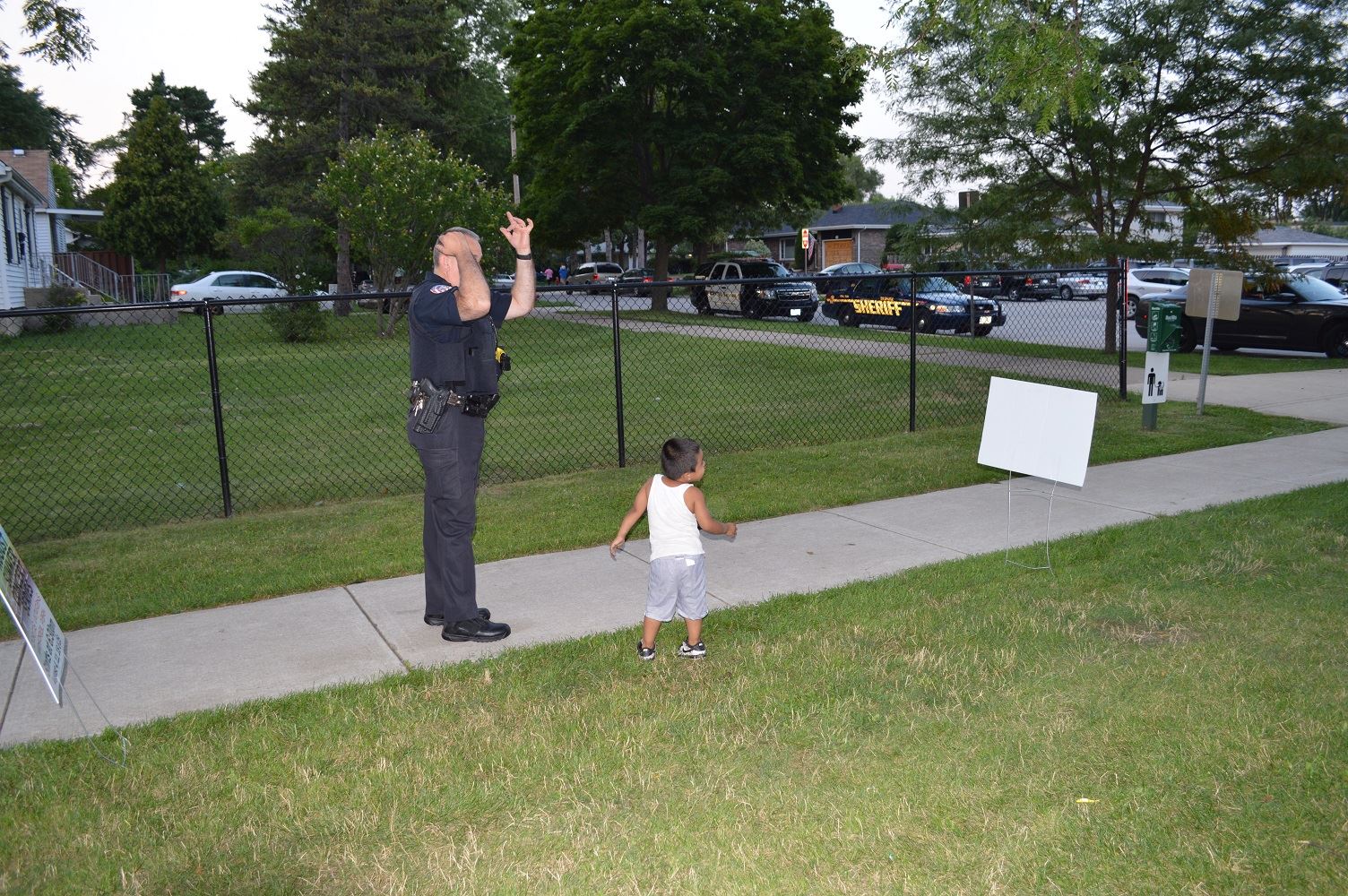 A Villa Park Police Officer plays with a young boy at a National Night Out event at the Iowa Community Center, Aug. 2.